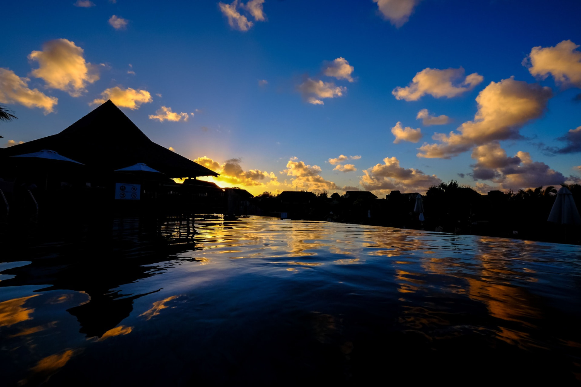 Sunset reflected in a Mauritius resort pool